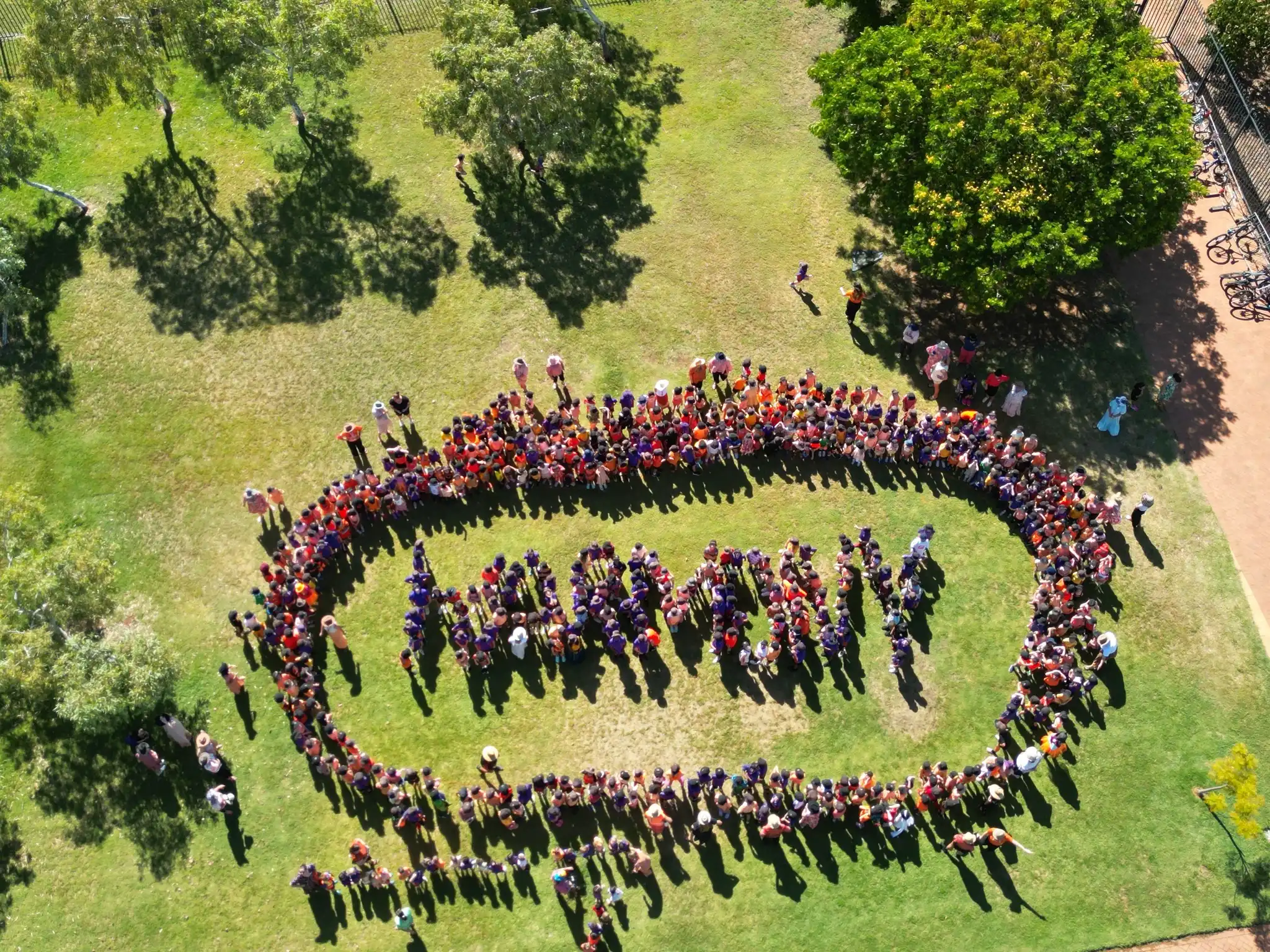 Aerial view students form word 'harmony' for harmony day
