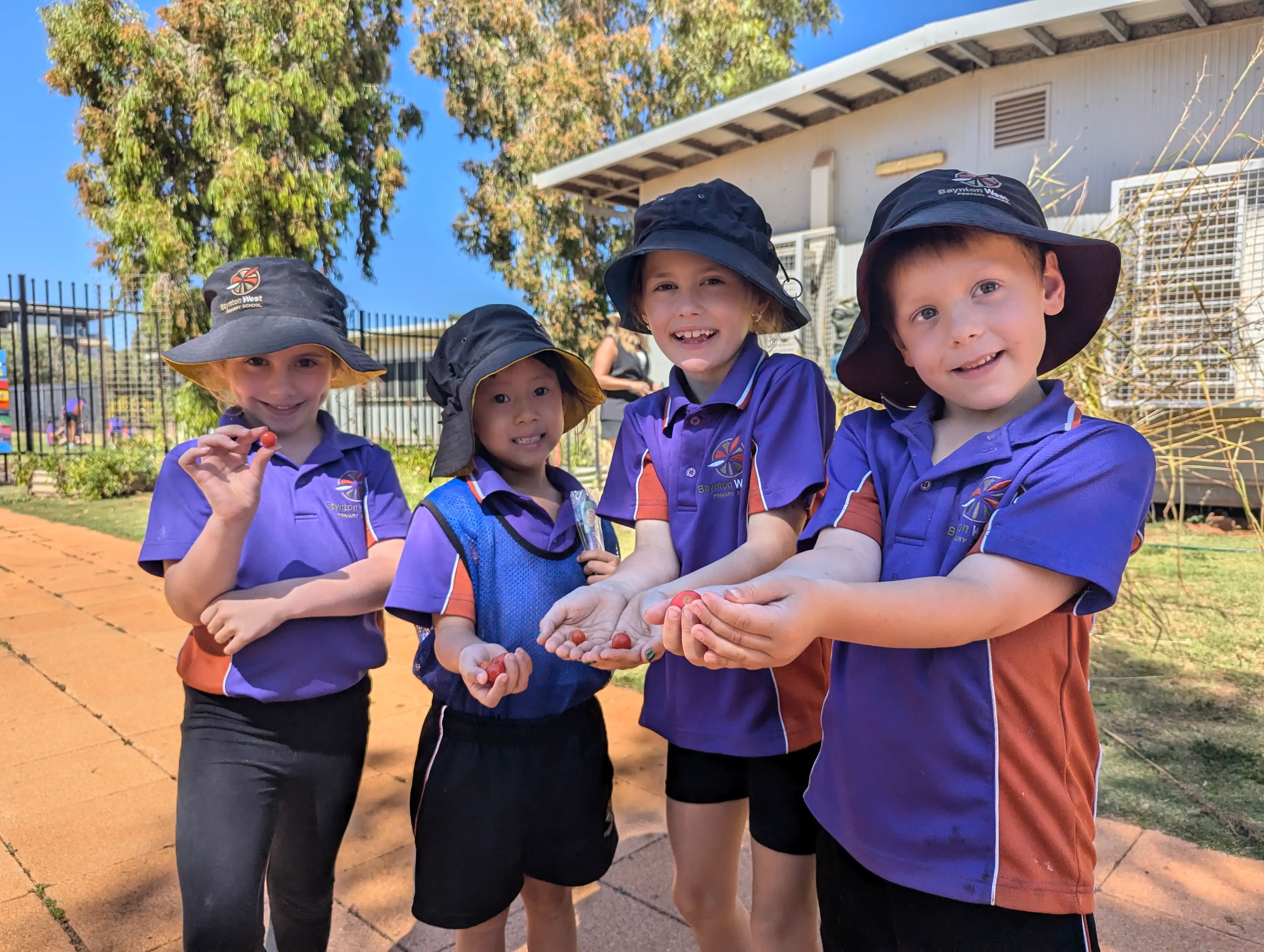 Students holding tomatoes