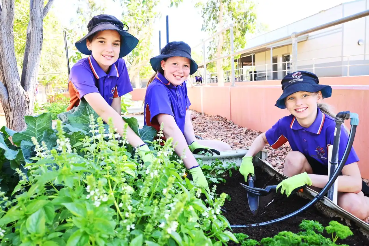Three students gardening